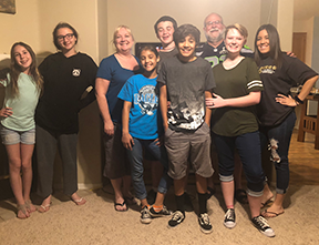 youth group seven youths posing with pastor ken and parent robin at ken's home