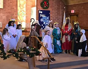 sunday school children thirteen children performing the christmas pageant at the alter
